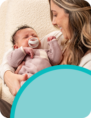 [Translate to Spanish (Reborn):] Mother with Baby and soother