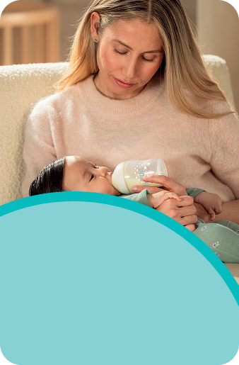 [Translate to Spanish (Reborn):] Mother with Baby and baby bottle